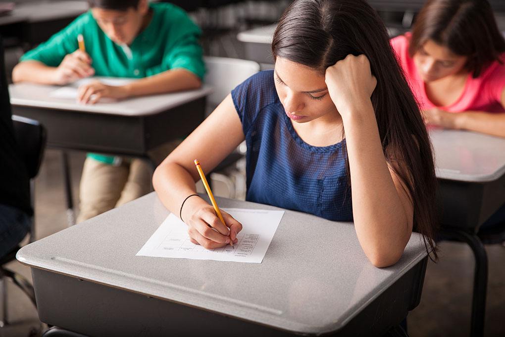 Group of high school students taking a test in a classroom