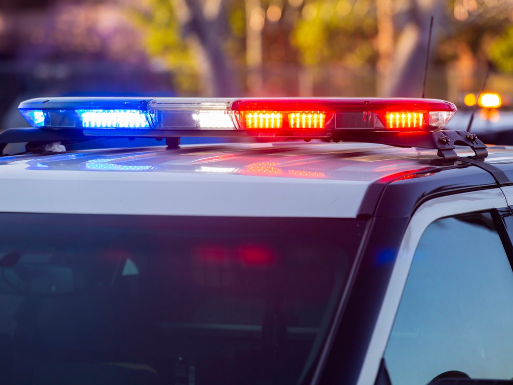 The light bar of a police vehicle, lit blue and red